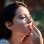 a woman with a cigarette in her mouth